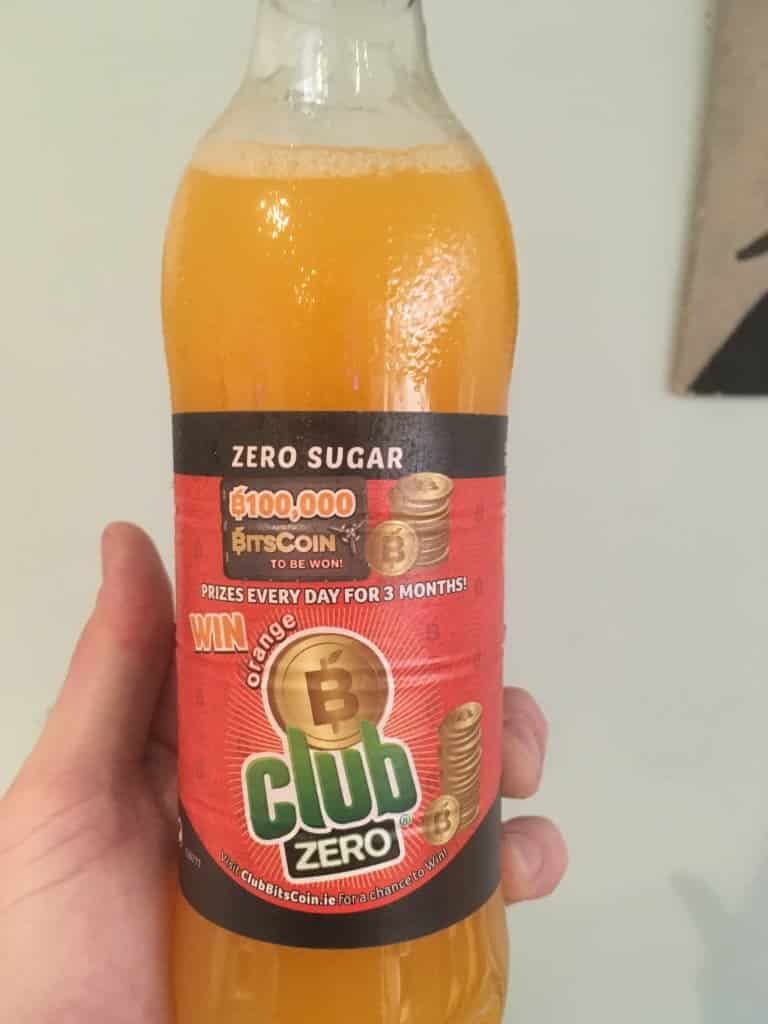 Front of the Club Orange Bottle with Club Bitscoin Promotion